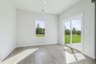 Located off the kitchen, the dining nook showcases luxury vinyl plank flooring and a large window.