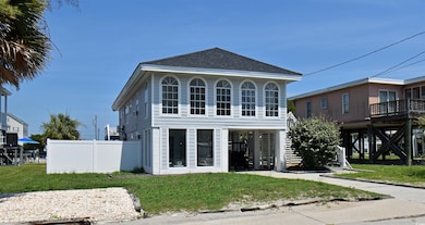 Rear view of house with a shingled roof