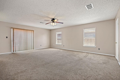 Unfurnished room featuring ceiling fan, plenty of