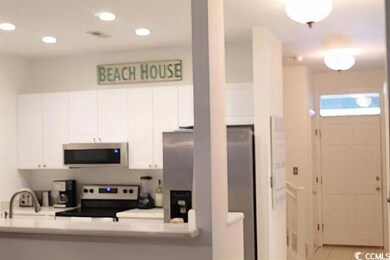 Kitchen with stainless steel appliances, white cab