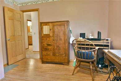 Office featuring light wood-style flooring and baseboards