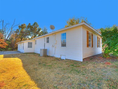 Rear view of property featuring a lawn