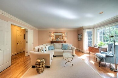 The formal living room is chic with hardwood floor