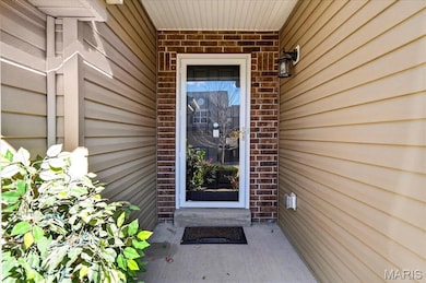 Doorway to property with brick siding