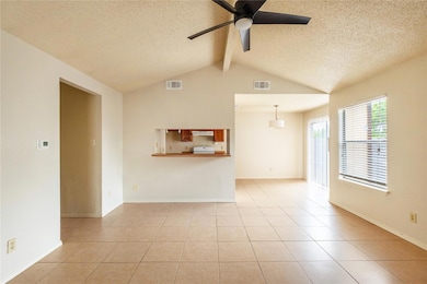 Unfurnished living room with a ceiling fan, a tex