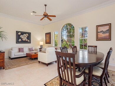 Tiled dining room featuring ceiling fan and crown