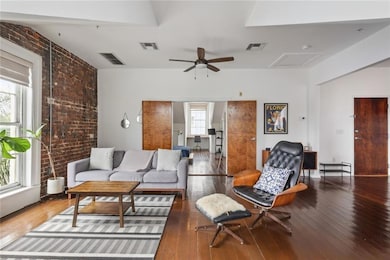 Walk into the natural light-flooded living room with views of downtown New Orleans and the Crescent City Connection