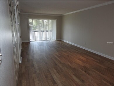 Living Room with Laminate Flooring / Sliders to th