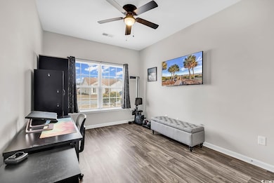 Home office with hardwood / wood-style floors and 