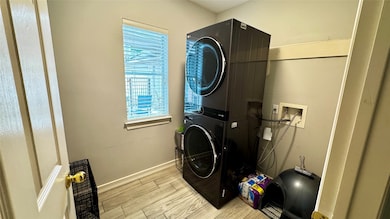 This laundry room features a stacked washer and dr