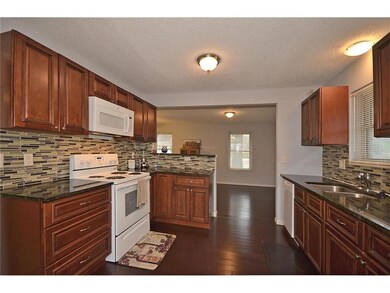 Beautifully updated kitchen featuring wood floors,