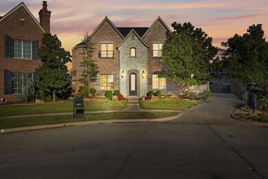View of front of house with a lawn at dusk