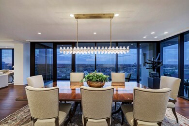 Another view of the Dining Room with a better view of the decorative chandelier as well as the additional art lighting installed to highlight the owner's sculpture.