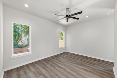 Empty room featuring recessed lighting, wood finished floors, and ceiling fan