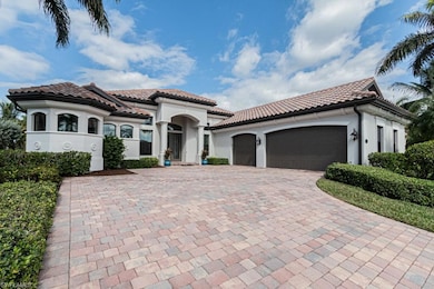 Mediterranean / spanish-style home featuring a gar
