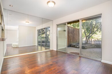 Dining room overlooking beautiful, peaceful patio and waterview, dark wood-type flooring and baseboards