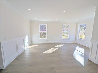 Unfurnished room featuring ornamental molding, rec