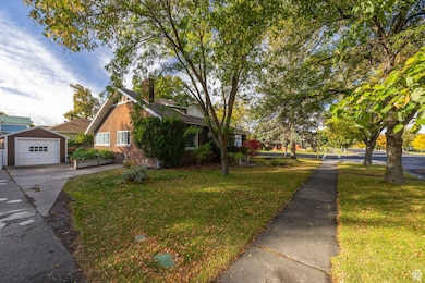 View of side of property featuring a yard,detached garage.