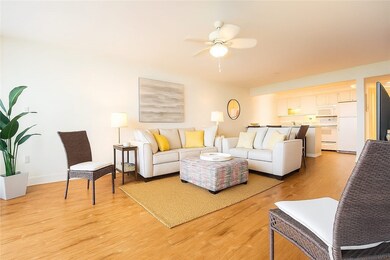 Living room with light wood finished floors and a ceiling fan