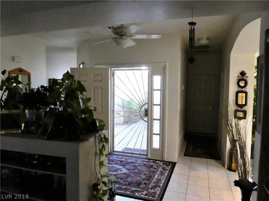 Looking back at front entry, hall to garage and la