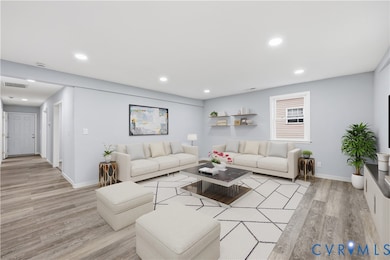Living area featuring light wood-style flooring and recessed lighting