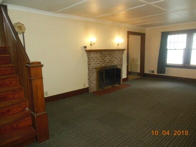 Living room to fireplace and dining room door