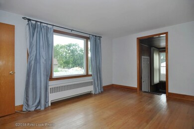 Large living room with hardwood floors.  Access to