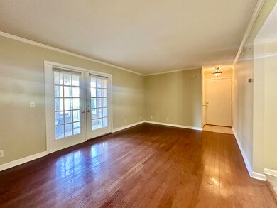 Living room with baseboards, french doors, dark wo