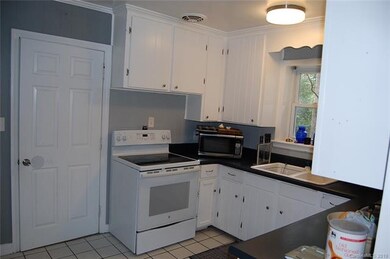 Kitchen features ceramic tile flooring and insulat