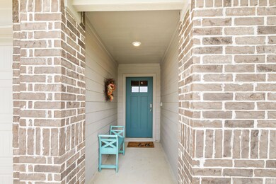 View of exterior entry with brick siding