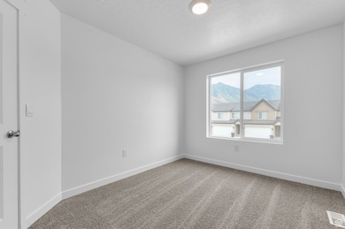 Carpeted spare room featuring baseboards and a mountain view