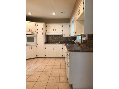 Tile floor and tons of cabinets and counter space