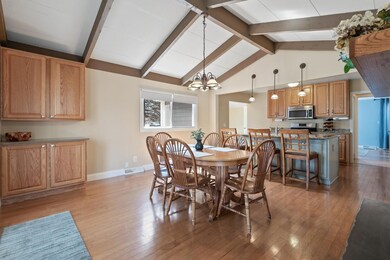 Spacious dining room with vaulted ceilings.