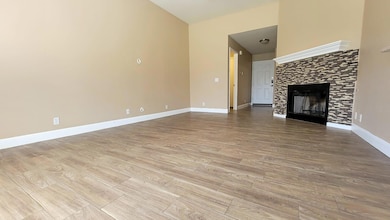 Unfurnished living room featuring a tiled firepla