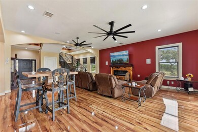 Living room with light wood-type flooring, stairs