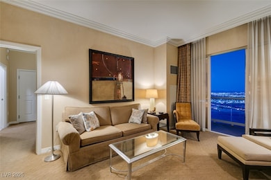 Living area featuring ornamental molding, visible