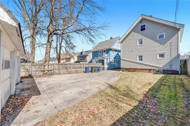 Virtually Staged Rear view of house featuring a fenced backyard, a lawn, and a patio
