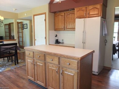 Kitchen has a built-in desk and is open to the din