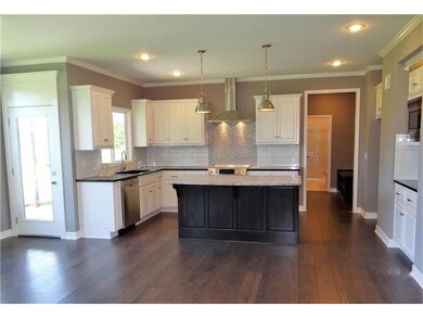 Kitchen is complete with granite counter tops, cen