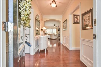 Hall with dark wood finished floors, a decorative 