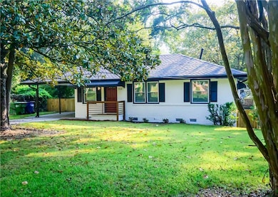 Ranch-style home with roof with shingles, brick siding, a carport, and crawl space