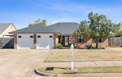 View of front of house with a front yard and a gar