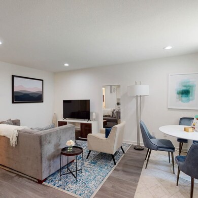 Living area with recessed lighting and light wood-style flooring