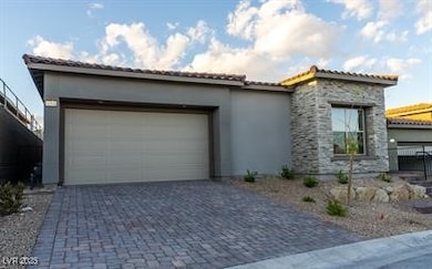 View of front facade featuring driveway, stucco si