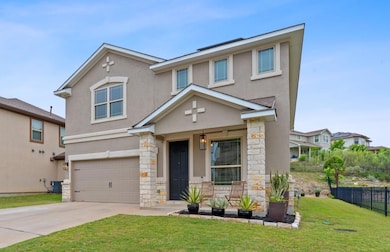 View of front facade with a front lawn, stone sid
