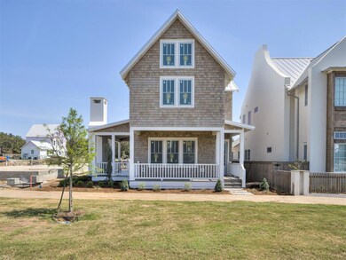 Rear view of property with a porch and a yard