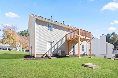 Back of property featuring a yard and a deck