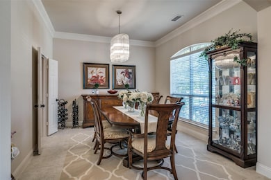 Dining space featuring a healthy amount of sunlight and crown molding