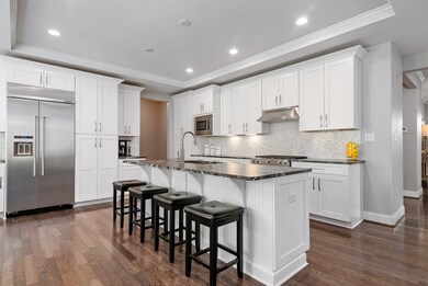 Kitchen Aid stainless steel appliances include a 5 burner gas range, microwave, dishwasher, disposal and refrigerator.