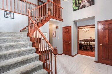 Wooden stair rail adds character to the bright ent